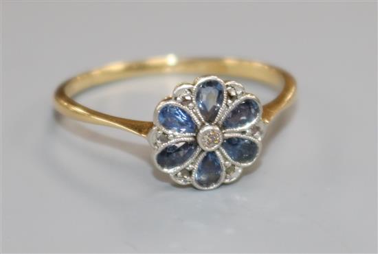 An 18ct gold and platinum, sapphire and diamond cluster flower head ring, size Q.